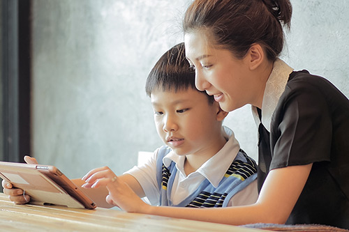 Mother & Child Reading on Tablet App